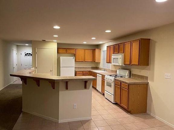 Big Kitchen with Island, gas range, tile flooring, built in microwave, alot of cabinetry, pantry