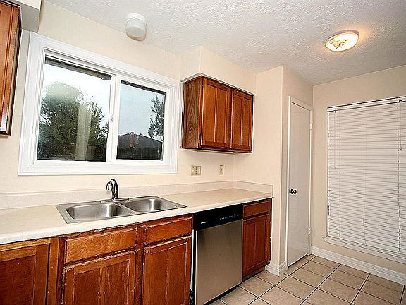 Another view of the kitchen with the stainless steel dishwasher.