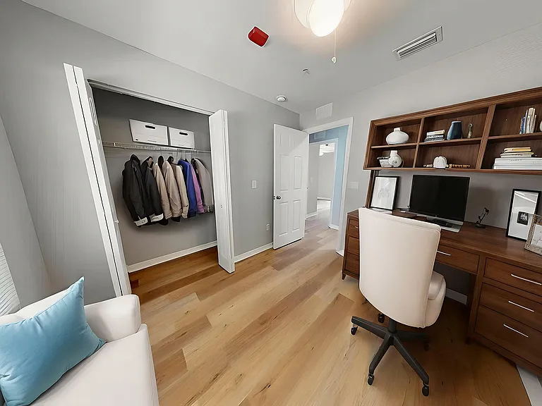 Elegant home office setup with warm wooden desk, stylish shelving, and cozy seating, perfect for productivity and comfort.