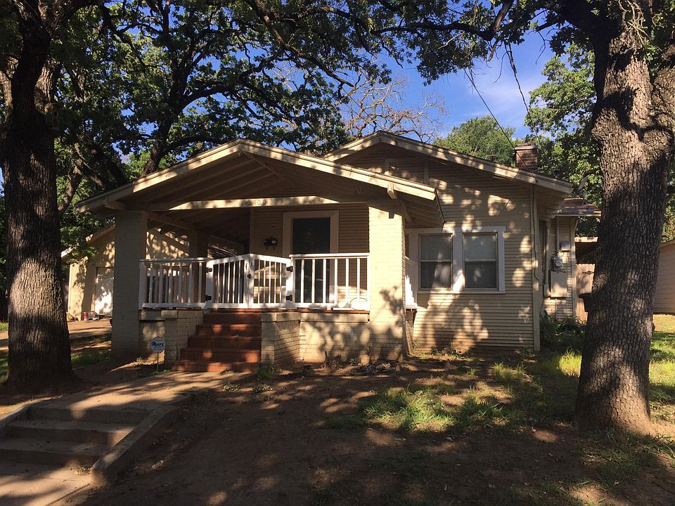 Front of house with wrap around porch