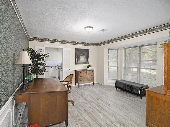 Formal dining with bay window, wainscoting, and tile floors
