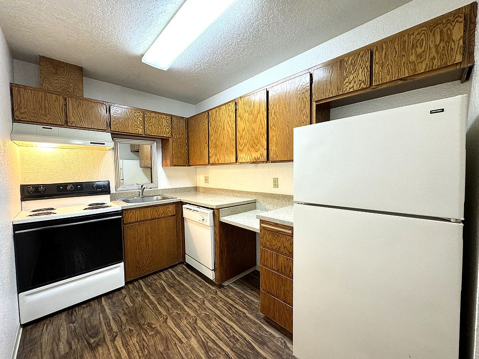 Kitchen with stove, refrigerator & dishwasher.