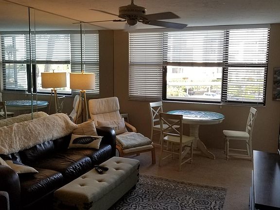 Living room & dining area with wall of mirror to reflect bea
