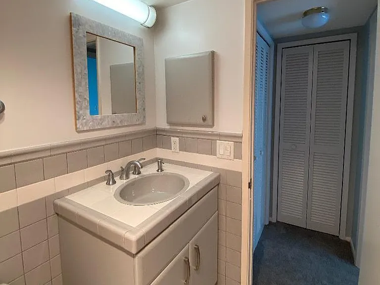 Custom custom height vanity, tile, Kohler plumbing fixtures. view of hall closet.