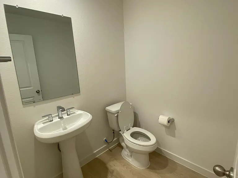 Half bathroom located by guest bedroom 3 and garage