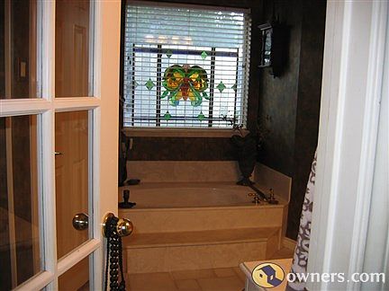 Master bathroom with tub, shower and large closets