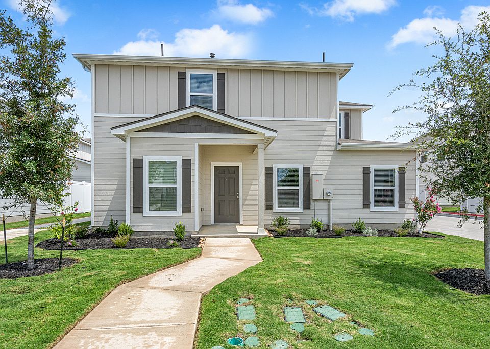 Exterior of the stunning Halpert plan with professional front yard landscaping.