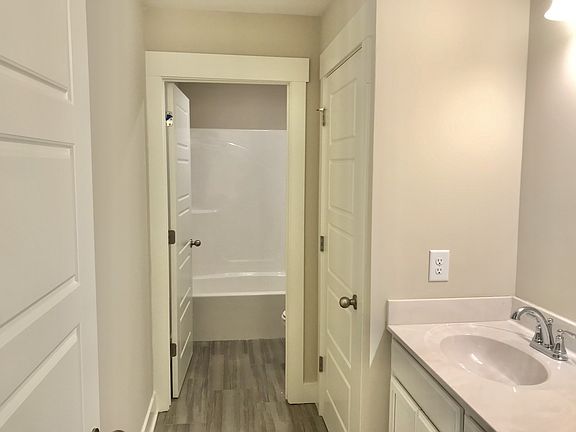 Stock photo of upstairs full bath with tile flooring and private toilet shower room. Upstairs featu