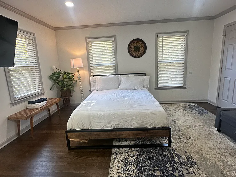 Relax in this cozy downstairs bedroom featuring a plush double bed and peaceful ambiance.