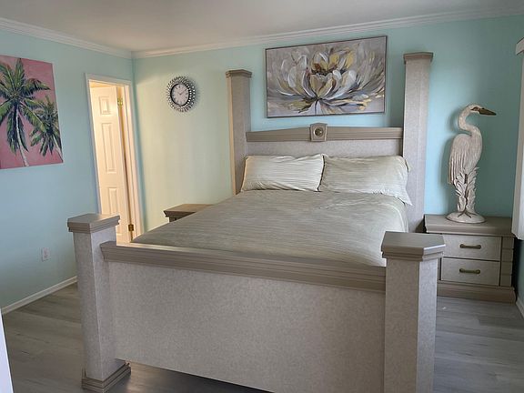 Primary bedroom with 2 night stands, Armoire, bathroom and walk in closet.
