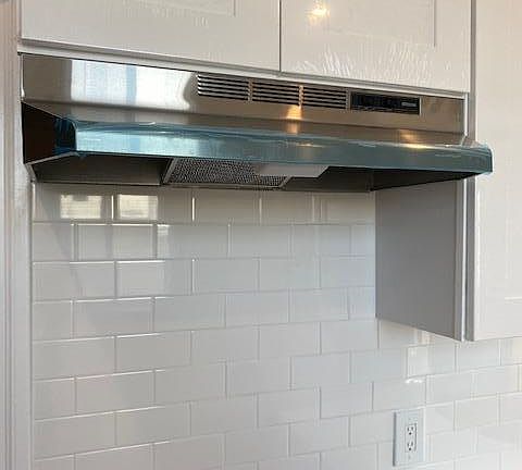 New stainless hood with storage cabinets above. New Stainless stove on order- GAS.
