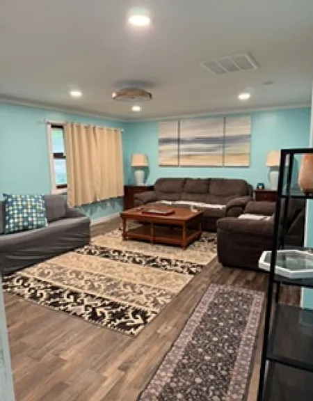 Large living room with sofa and loveseat as well as a pull out sofa bed. Spacious with plenty of room and new television with internet so you can use your favorite apps.