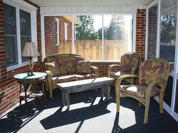 Screened-in sun porch with new carpet and screens. Outdoor furniture included.