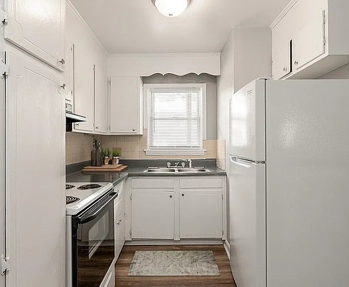 Experience culinary delight in this cozy and well-lit kitchen space.