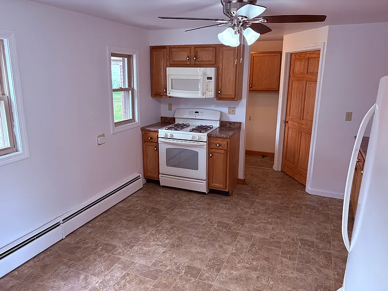 Full Kitchen, with appliances, including refrigerator, stove, Microwave.