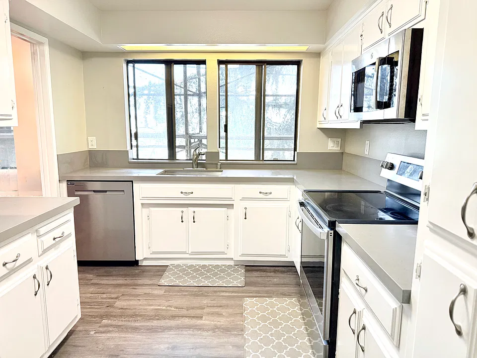 Kitchen with all modern stainless steel appliances including a brand new dishwasher, plenty of storage and counter space