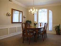 Formal Dining room is accented with wainscoting and dentil molding that is carried through to Den