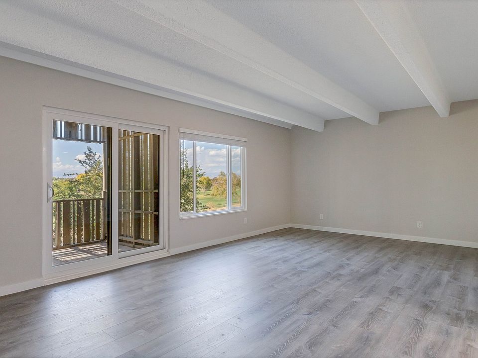 Large living room! Balcony and picture window with mountain and golf course views.