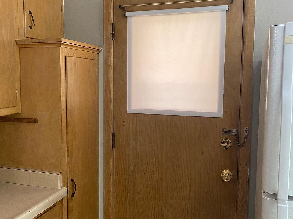 Kitchen back door, pantry to left and fridge to right