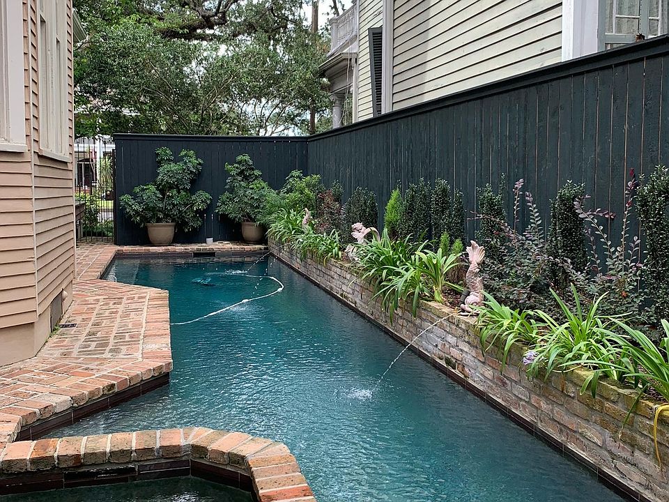Looking from the cottage towards the entry gate-view of the pool.