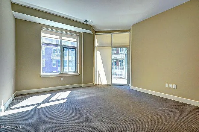 Master bedroom. Balcony access with view to serene courtyard and water fountain.