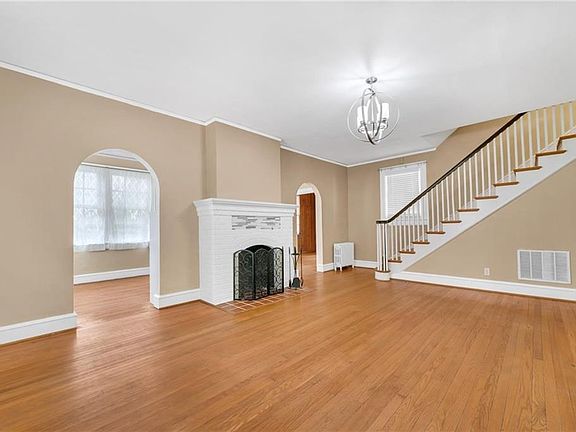 Spacious living room with hardwood floors and fireplace