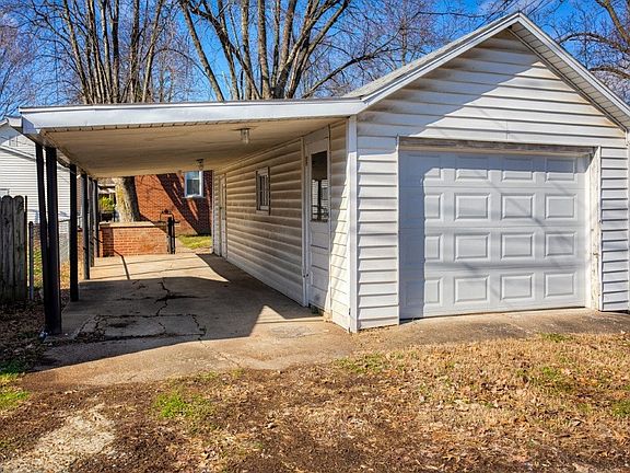 Detached garage with attached carport