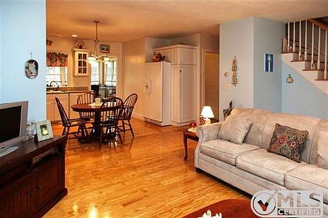 View of living room looking into kitchen/dining room area