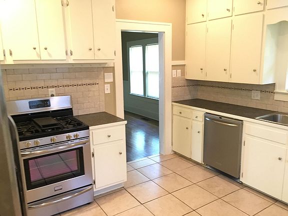 Kitchen with stainless steel appliances looking towards dining room