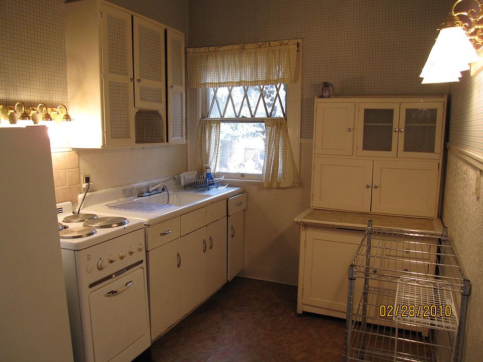 Kitchen with Hoosier antique baking center. Full stove and frig. with freezer