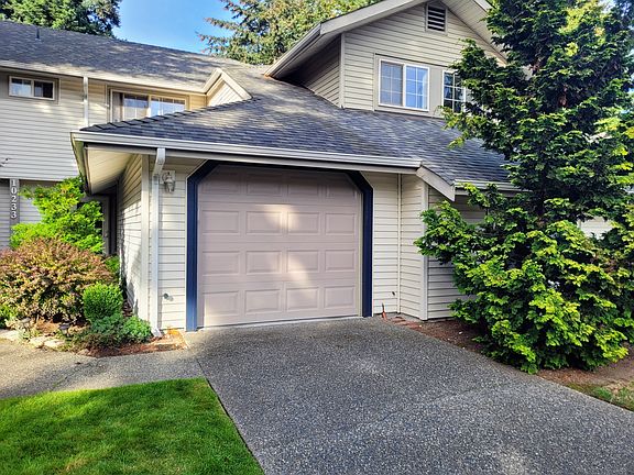 1 Car garage with a space for another in the driveway.