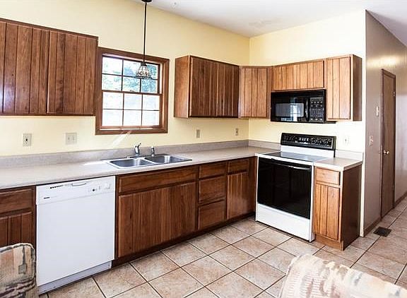 Open Kitchen overlooking the woods.  The hall to the right side is lined with cabinets and a storage pantry