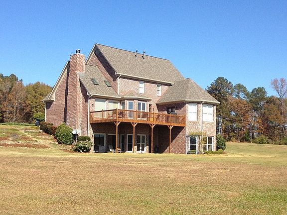 Rear view with large backyard, great for outdoor activities.