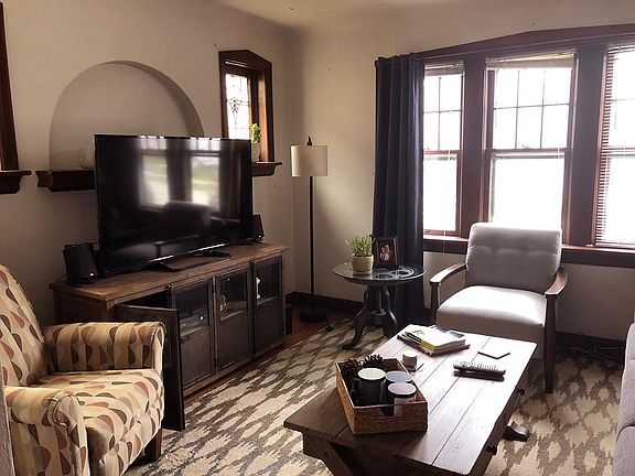 Living room with stained glass and wood flooring