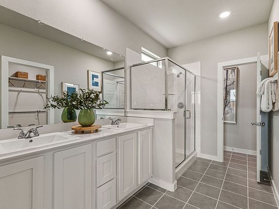 Primary Bathroom in the Stanley II home plan by Trophy Signature Homes - REPRESENTATIVE PHOTO