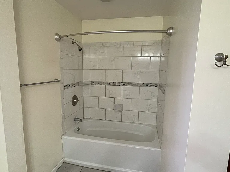 Accessible suite bathroom w/ standard tub. Grab bars and transfer bench can by added.