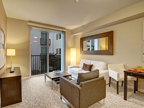 A cozy living area with large sliding glass doors leading out to the Juliet balcony