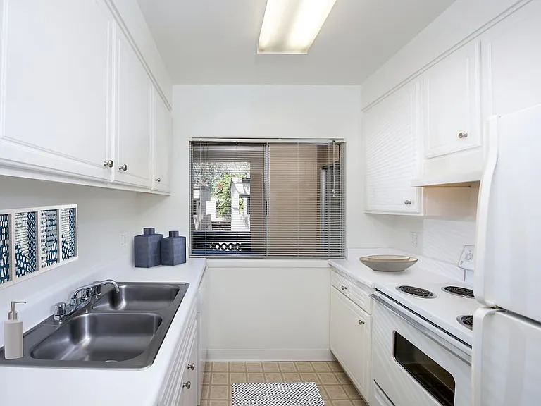 Classic kitchen with white cabinetry and white appliances