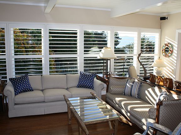 Living room with new wood floors and plantation shutters