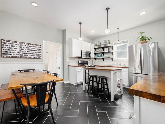 Eat-In Kitchen with Tile Flooring and Stainless Appliances