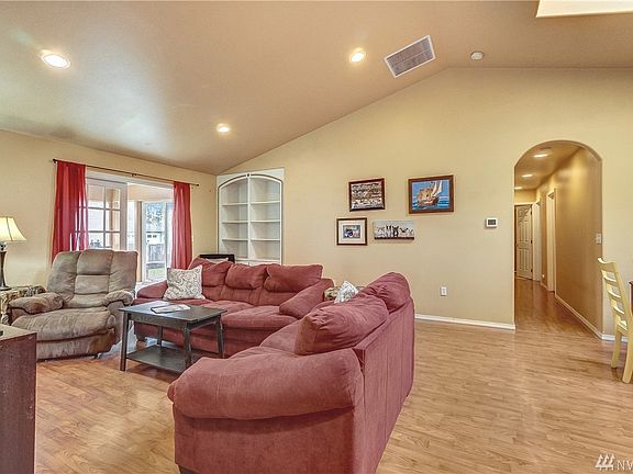 The living room has vaulted ceilings and easy care flooring throughout the home. 