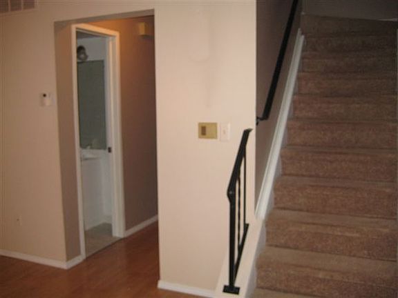 Staircase to bedrooms/hallway to kitchen and dining area, vi