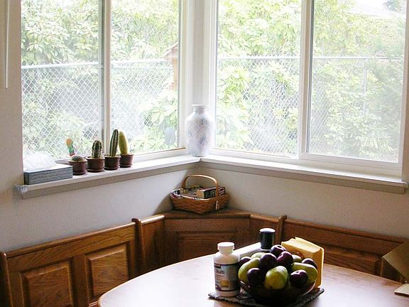 Lots of Sunlight shines in the separate oak breakfast nook.