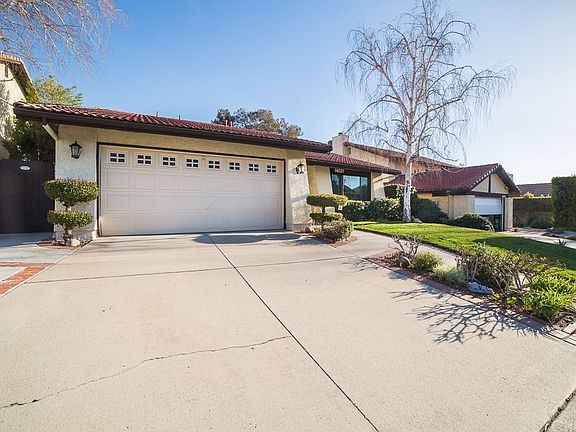 Concrete driveway provides parking for 2 cars and