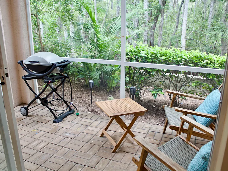 Back lanai overlooking preserve with small BBQ grill