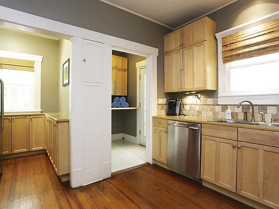 To your right is the laundry room that leads out to the backyard and to the left is the refrigerator area and more pantry area.