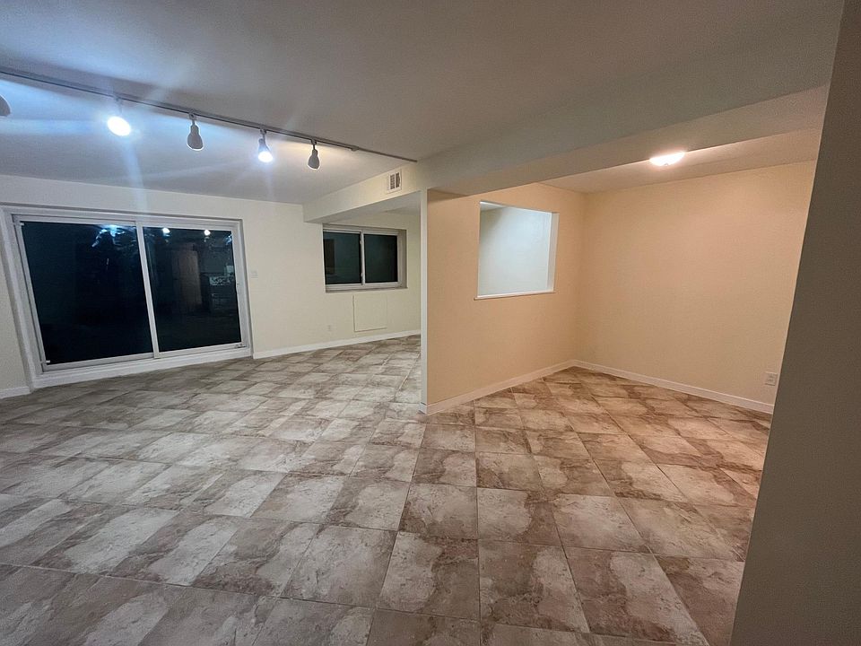 living room and dining room with glass doors to balcony