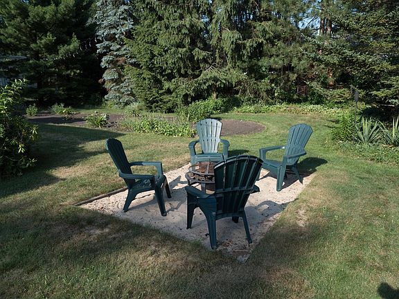 Fire pit area. Colorado Blue Spruce, Northern Pine, White Pine, Australian Pine, Balsam Fir trees surround.