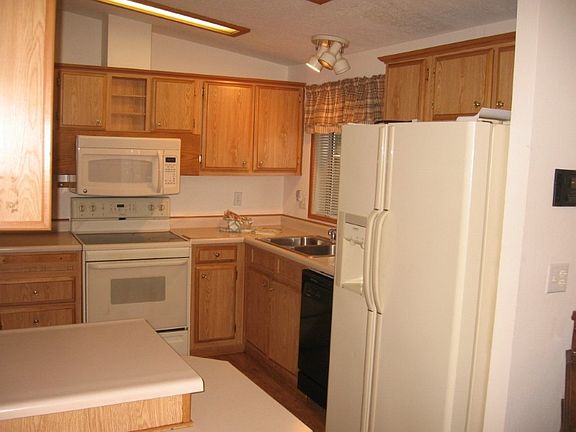 Efficient kitchen and all appliances stay including washer/dryer in large laundry room w/sink.
