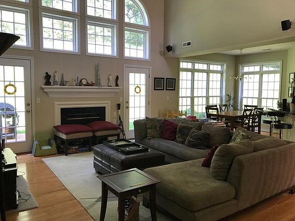Large great room/ family room with 2 story windows, gas fire
